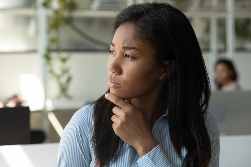 A businesswoman reflecting on her legal payroll requirements